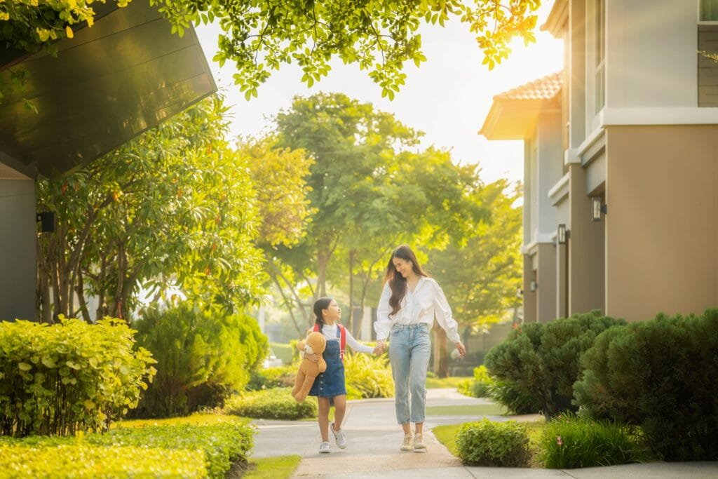 a mother and daughter walking in their village