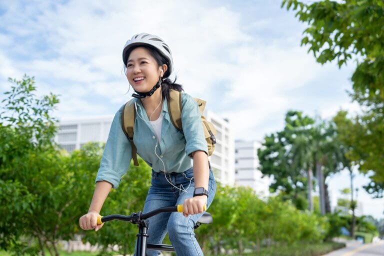 a woman riding a bicycle in her village